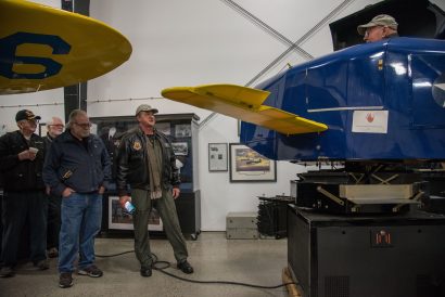 A tour group looks at a Link Trainer.